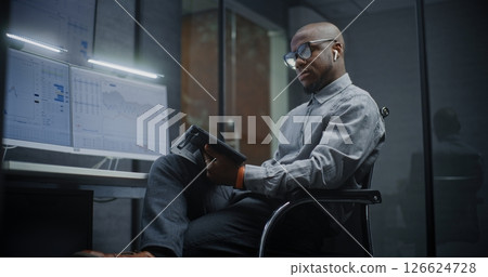 Financial Analyst Analyzing Real-Time Stocks, Exchange Market Charts Using Digital Tablet Financial Analyst Analyzing Real-Time Stocks, Exchange Market Charts Using Digital Tablet 126624728