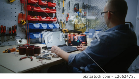 Man Checking Real-Time Stocks Using Laptop, Watching Online Trading Tutorial on Digital Tablet Man Checking Real-Time Stocks Using Laptop, Watching Online Trading Tutorial on Digital Tablet 126624753