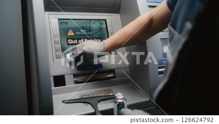 Cleaner Wiping Vandalized ATM Screen with Rag, Removing Graffiti Cleaner Wiping Vandalized ATM Screen with Rag, Removing Graffiti 126624792