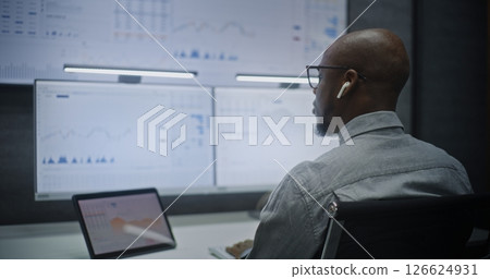 Investment Agent Working in Financial Agency Office at Night, Monitoring Real-Time Stocks 126624931