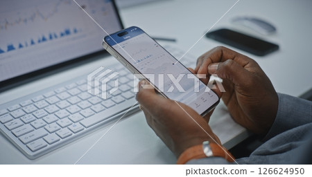 Financial Analyst Checking Real-Time Stocks on Smartphone and Digital Tablet Financial Analyst Checking Real-Time Stocks on Smartphone and Digital Tablet 126624950