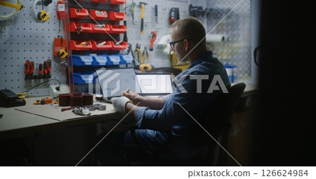 Craftsman Doing Handwork, Monitoring Real-Time Stock on Laptop and Tablet Computer in Workshop 126624984