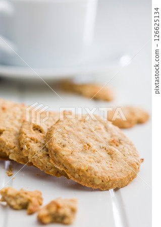 Sweet oatmeal cookies on white table. 126625134