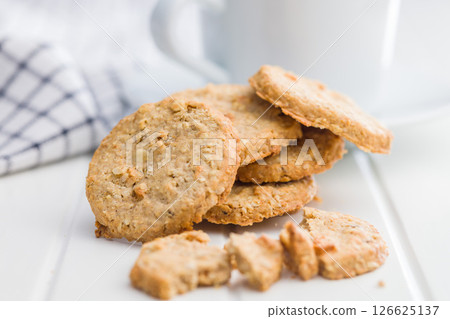 Sweet oatmeal cookies on white table. Sweet oatmeal cookies on white table. 126625137