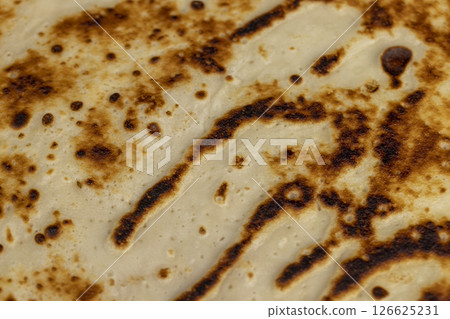 background of large pancakes made from milk and flour, hot pancakes made from milk with wheat flour of varying degrees of roasting background of large pancakes made from milk and flour, hot pancakes made from milk with wheat flour of varying degrees of roasting 126625231