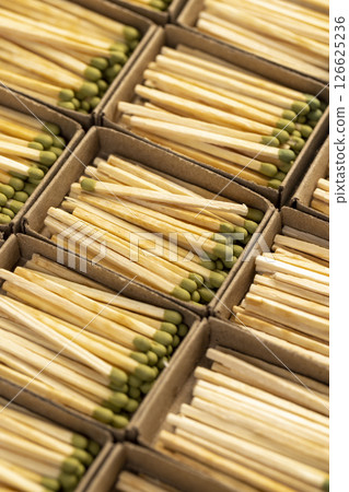 wooden matches with head in matchbox, the green head of a wooden match laid out in cardboard boxes, close up wooden matches with head in matchbox, the green head of a wooden match laid out in cardboard boxes, close up 126625236