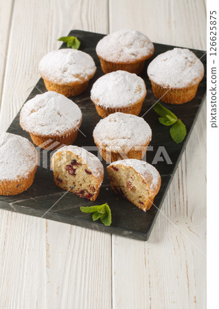 Stollen Small fruitcakes for Christmas dinner closeup on the board . Vertical Stollen Small fruitcakes for Christmas dinner closeup on the board . Vertical 126625875