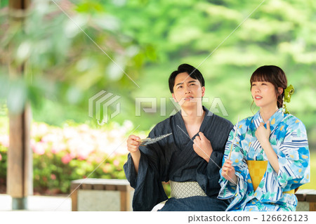 A couple in yukata cooling off in a gazebo A couple in yukata cooling off in a gazebo 126626123