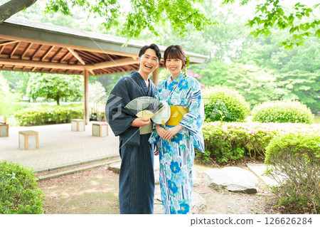 A couple in yukata strolling through a Japanese garden A couple in yukata strolling through a Japanese garden 126626284