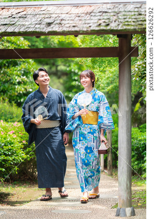 A couple in yukata strolling through a Japanese garden A couple in yukata strolling through a Japanese garden 126626292