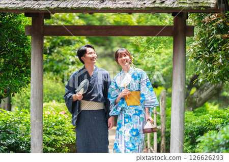 A couple in yukata strolling through a Japanese garden A couple in yukata strolling through a Japanese garden 126626293