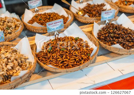 Fried Insects,Fried silkworms and other insect varieties are attractively arranged in woven baskets or various containers Fried Insects,Fried silkworms and other insect varieties are attractively arranged in woven baskets or various containers 126627067
