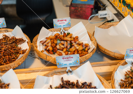 Fried Insects,Fried silkworms and other insect varieties are attractively arranged in woven baskets or various containers Fried Insects,Fried silkworms and other insect varieties are attractively arranged in woven baskets or various containers 126627069