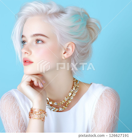 A stunning young woman with vibrant white and teal hair, striking blue eyes,chic jewelry looks thoughtfully to the side.blue background is perfect for fashion,beauty, hair care,lifestyle content. 126627191