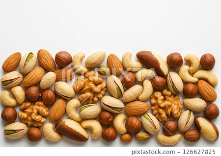 Assorted mixed nuts on simple white background highlighting variety of nut textures and shapes. concept of healthy snack, natural protein source, nutty flavors, white background, copy space 126627825