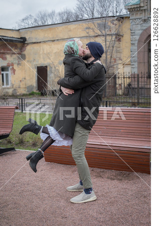 Carefree woman and man walking in the park. Beautiful young couple outdoors portrait Carefree woman and man walking in the park. Beautiful young couple outdoors portrait 126628892