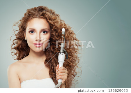 Close-up portrait of young model woman with long curly wavy hairstyle  126629053