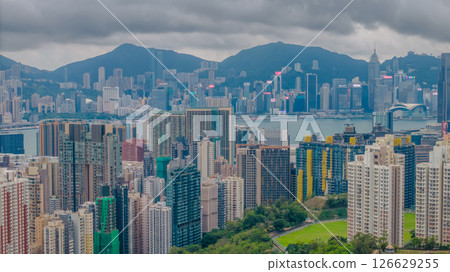 Packed Urban Buildings Overlooking Harbor Under Cloudy Skies Packed Urban Buildings Overlooking Harbor Under Cloudy Skies 126629255