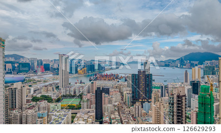 View of a Modern City Skyline Under Cloudy Skies 126629293