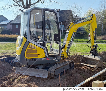 Excavator on earthmoving. Open-pit mining. Backhoe dig sand, ground in quarry. Heavy construction equipment on excavation on construction site. Excavator on groundwork, foundation. Road construction. Excavator on earthmoving. Open-pit mining. Backhoe dig sand, ground in quarry. Heavy construction equipment on excavation on construction site. Excavator on groundwork, foundation. Road construction. 126629362