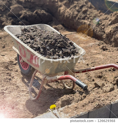 Rusted wheelbarrow filled with compost, sustainable gardening concept, eco friendly farming, organic waste management, Earth Day preparation 126629368