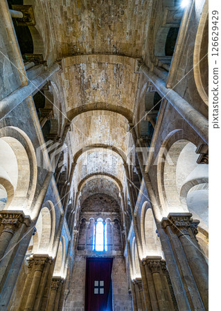 Coimbra , Portugal - Mar 14, 2025: Interior of the Old Cathedral of Coimbra, Se Velha at Coimbra, Portugal. Coimbra , Portugal - Mar 14, 2025: Interior of the Old Cathedral of Coimbra, Se Velha at Coimbra, Portugal. 126629429