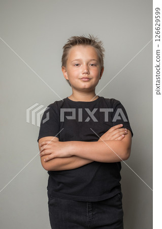 Successful young child boy in black t-shirt on white background 126629599