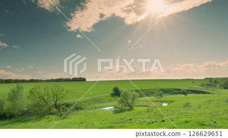 A Serene Green Landscape with a Beautiful Sunlit Sky and Absolutely Breathtaking Scenery Time lapse. A Serene Green Landscape with a Beautiful Sunlit Sky and Absolutely Breathtaking Scenery Time lapse. 126629651