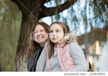 Happy family having fun in park. Mother and daughter portrait 126629883