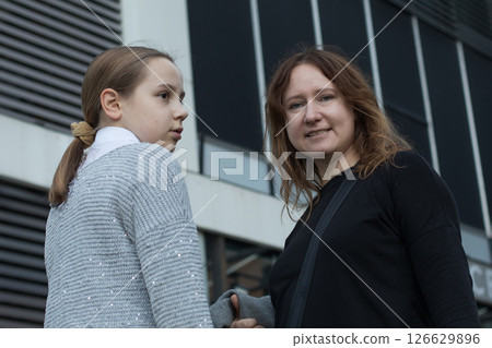 Portrait of mother and daughter outdoors together. Family lifestyle portrait 126629896