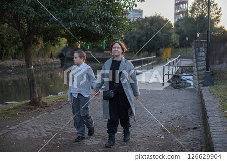 Happy family having fun in park. Mother and daughter portrait Happy family having fun in park. Mother and daughter portrait 126629904