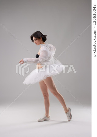 Elegant ballet dancer showcases beauty in lingerie and tulle in the studio 126630048