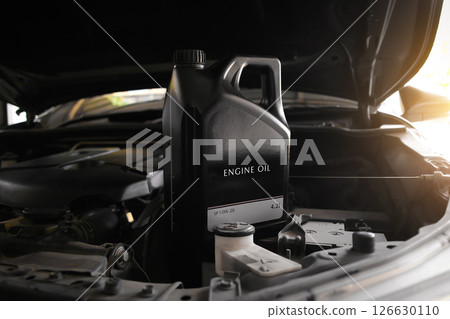 Engine Oil or Motor Oil, A black container sits in the open engine bay Engine Oil or Motor Oil, A black container sits in the open engine bay 126630110