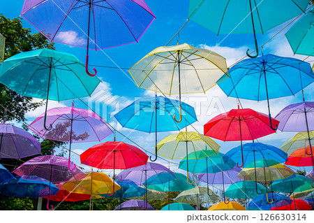 Umbrella Sky - Colorful umbrellas dancing in the summer sky 126630314