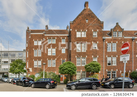 A striking blend of historic brick architecture set against modern developments, showcasing urban evolution and design contrast. 126630474
