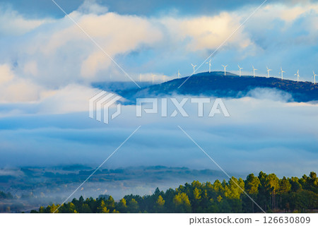 Foggy valley and wind turbines in clouds Foggy valley and wind turbines in clouds 126630809