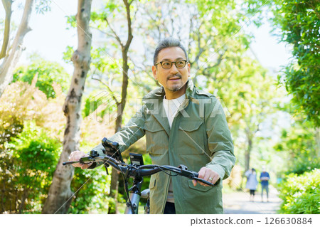 Portrait of a middle-aged man with an electric bicycle Portrait of a middle-aged man with an electric bicycle 126630884