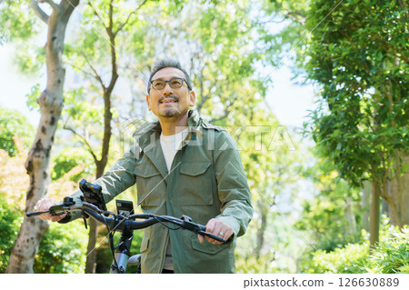 Portrait of a middle-aged man with an electric bicycle 126630889