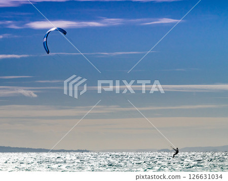 Kite surfer riding waves. Kiteboarding sport. 126631034