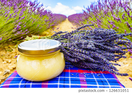 Jar with honey and lavender flowers. Jar with honey and lavender flowers. 126631051