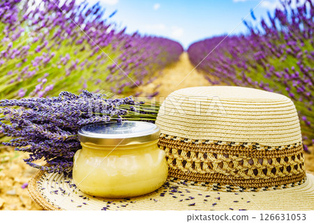 Summer hat and jar with honey at lavender field. Holidays in France. 126631053