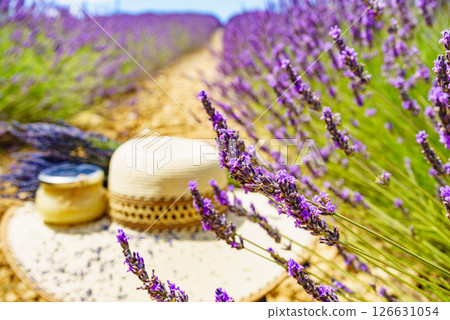 Summer hat and jar with honey at lavender field. Holidays in France. Summer hat and jar with honey at lavender field. Holidays in France. 126631054