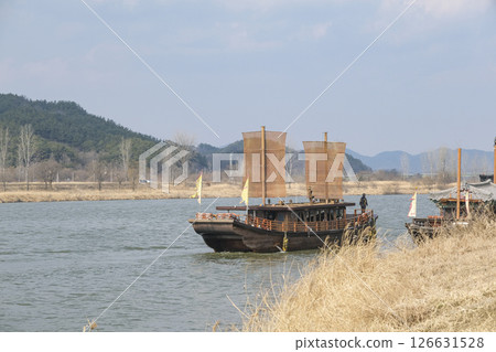 A wooden sightseeing boat cruising around the Baekba River A wooden sightseeing boat cruising around the Baekba River 126631528