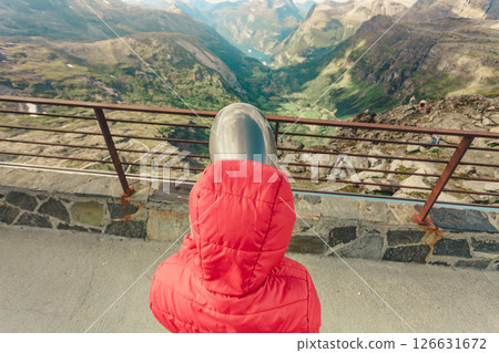 Tourist looking through binoculars in mountains, Norway Tourist looking through binoculars in mountains, Norway 126631672