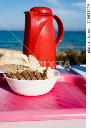 Bread slices and thermos on beach Bread slices and thermos on beach 126631699