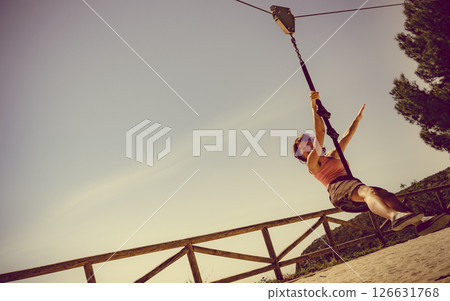 Adult woman having fun on zipline Adult woman having fun on zipline 126631768