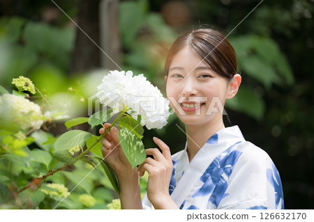 Cute woman in yukata with hydrangeas looking at camera Cute woman in yukata with hydrangeas looking at camera 126632170