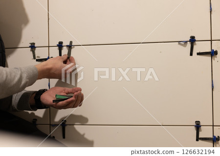Man Installing Tile Leveling System Components. 126632194