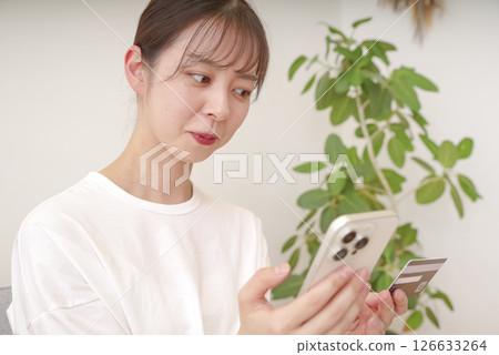 Young woman making payment on her smartphone Young woman making payment on her smartphone 126633264