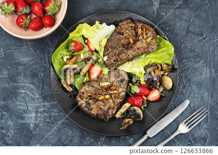 Piece of roast beef with strawberries. Piece of roast beef with strawberries. 126633866